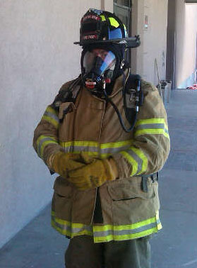 Picture of DJ in full firefighting gear during a training exercise