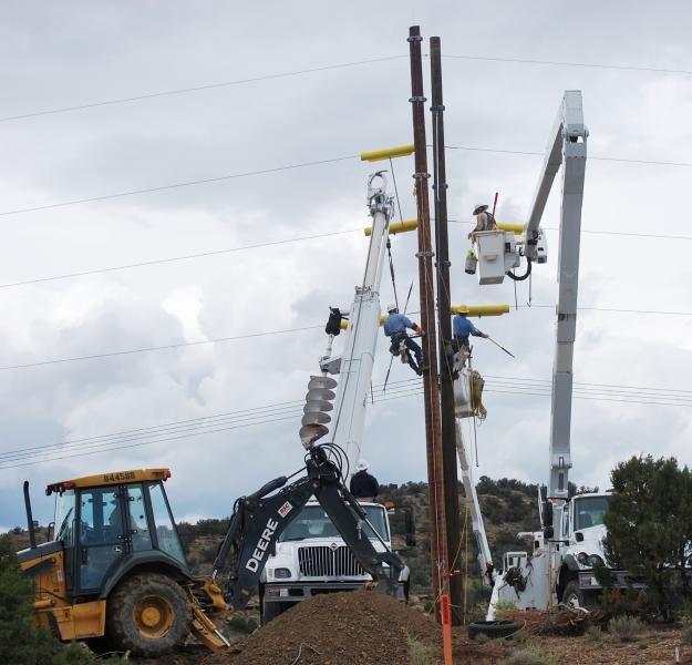 Navajo Tribal Utility Authority construction crews prepare electric infrastructure for installation of fiber-optic cable 