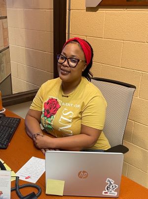 Photo of Victoria Wilson in front of a laptop, sitting in a computer.