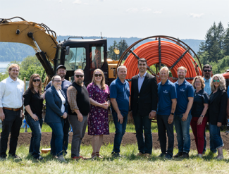a group of people standing on a lawn in front of a tractor